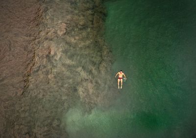 Aerial view of mid adult man swimming in sea