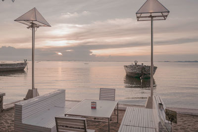 Lifeguard hut on sea against sky during sunset