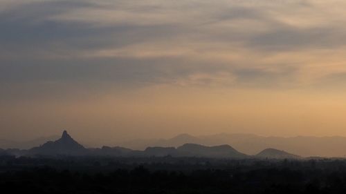 Scenic view of silhouette mountains against sky during sunset