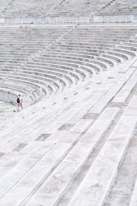 High angle view of people walking on tiled floor