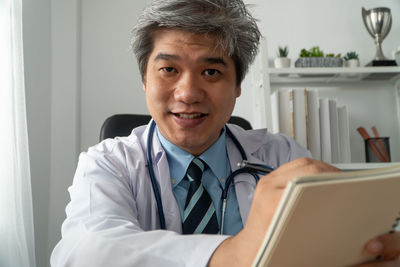 Portrait of smiling man using smart phone