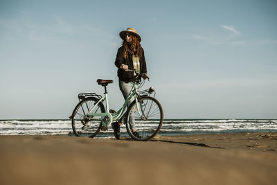 Bicycle on beach against sky