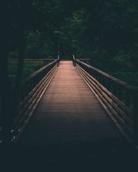 Empty wooden footbridge in forest