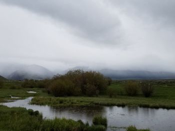 Scenic view of lake and mountains against sky