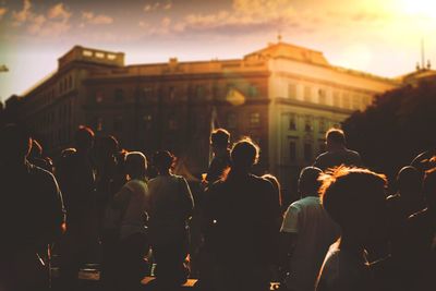 Group of people in city at sunset