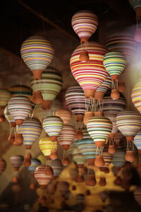 Low angle view of illuminated lanterns hanging at market stall