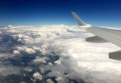 Aerial view of cloudscape over airplane wing