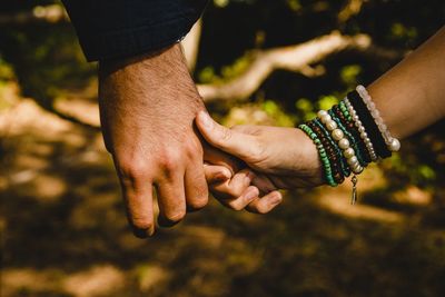 Cropped image of couple holding hands