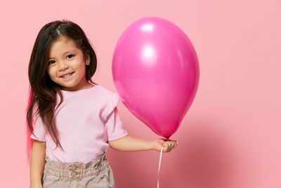 Portrait of young woman with balloons