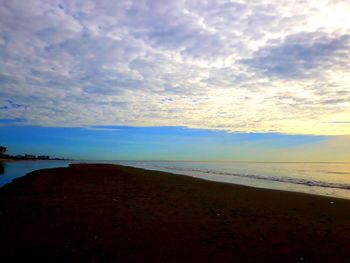 Scenic view of beach against sky during sunset