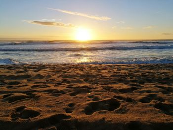 Scenic view of beach against sky during sunset