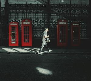 Side view of a man walking on street