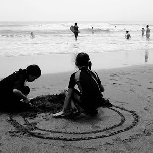 Rear view of people on beach