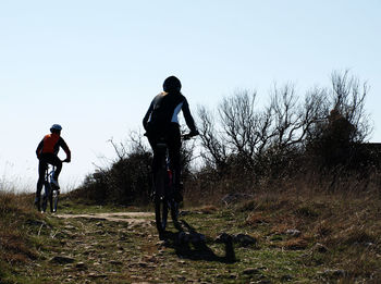 Man riding bicycle on field