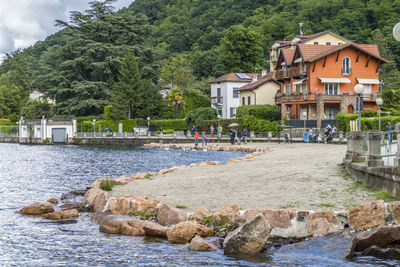 Houses by sea and buildings in city