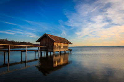 Built structure by sea against blue sky