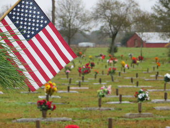 American flag and vases at cemetery