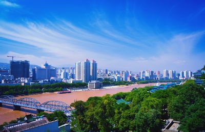 View of cityscape against blue sky