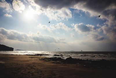 View of calm sea against cloudy sky