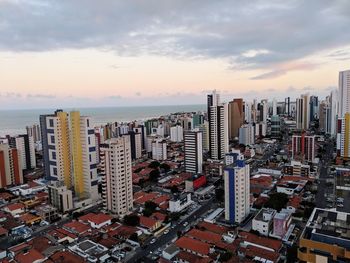 High angle view of modern buildings against sky during sunset