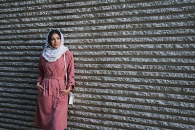 Woman standing against wall