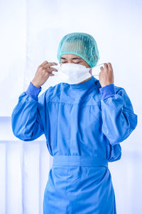 Doctor wearing mask against white background