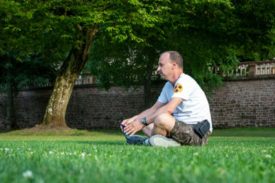 Full length of a man sitting on grassland