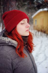 Portrait of woman in hat during winter