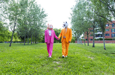 Rear view of women walking on grass