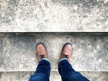 Low section of man standing on steps