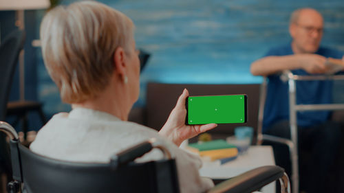 Side view of woman using mobile phone