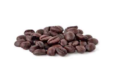 Close-up of coffee beans against white background