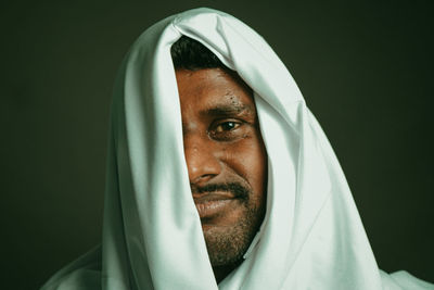 Portrait of mid adult man against black background