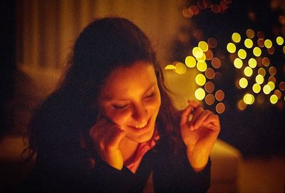 Close-up of woman standing at night