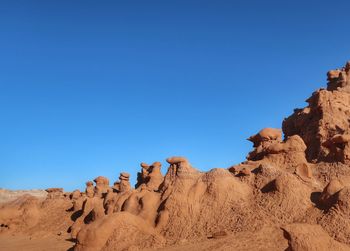 Landscape of many small toadstool like rock formations in goblin valley state park in utah