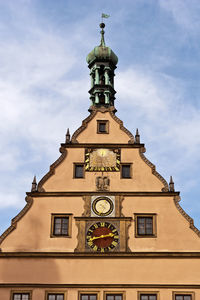 Low angle view of clock tower against sky