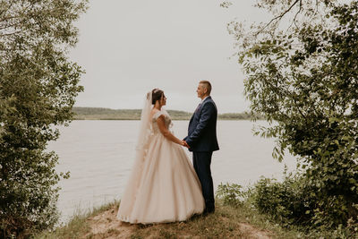 Rear view of couple standing on field