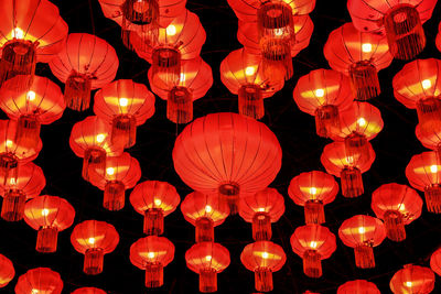 Low angle view of illuminated lanterns hanging at night