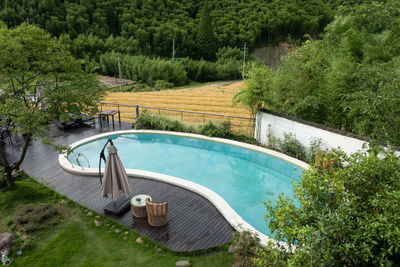 High angle view of swimming pool by trees