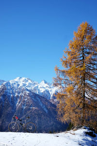 Scenic view of snowcapped mountains against clear blue sky