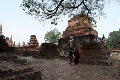 Tourists at temple against building