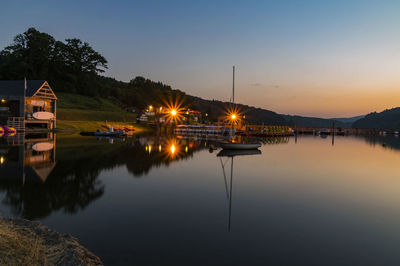 Scenic view of lake against sky at sunset