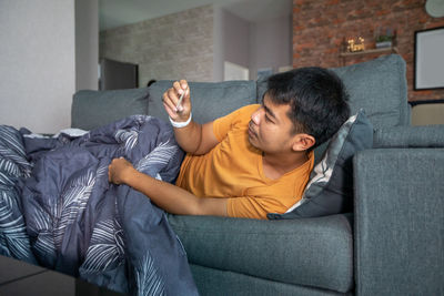 Man sitting on sofa at home