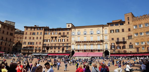 Group of people in front of buildings in city