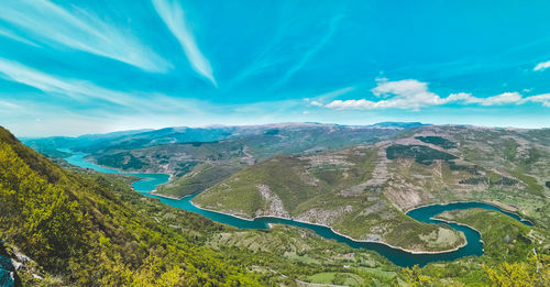 Scenic view of mountains against blue sky