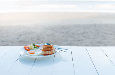 Close-up of food in plate on table at beach