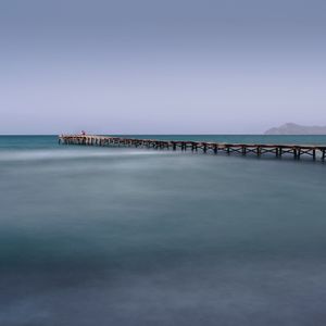 Pier over sea against clear sky