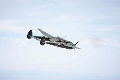 Military airplane flying against sky