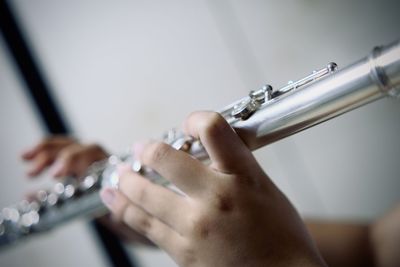 Cropped image of girl playing flute