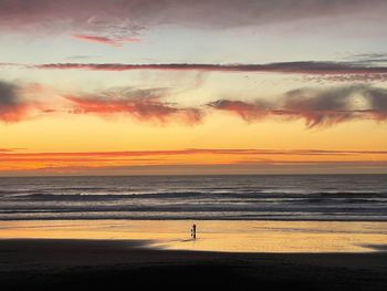 Scenic view of beach against sky during sunset